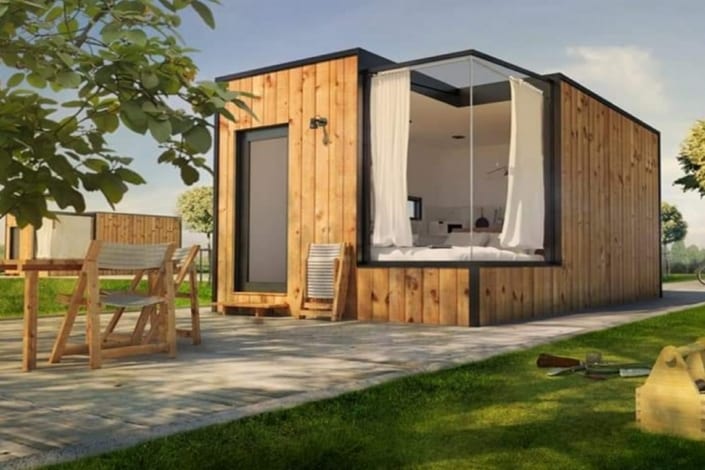 An image of a mini custom home in a grassy area.