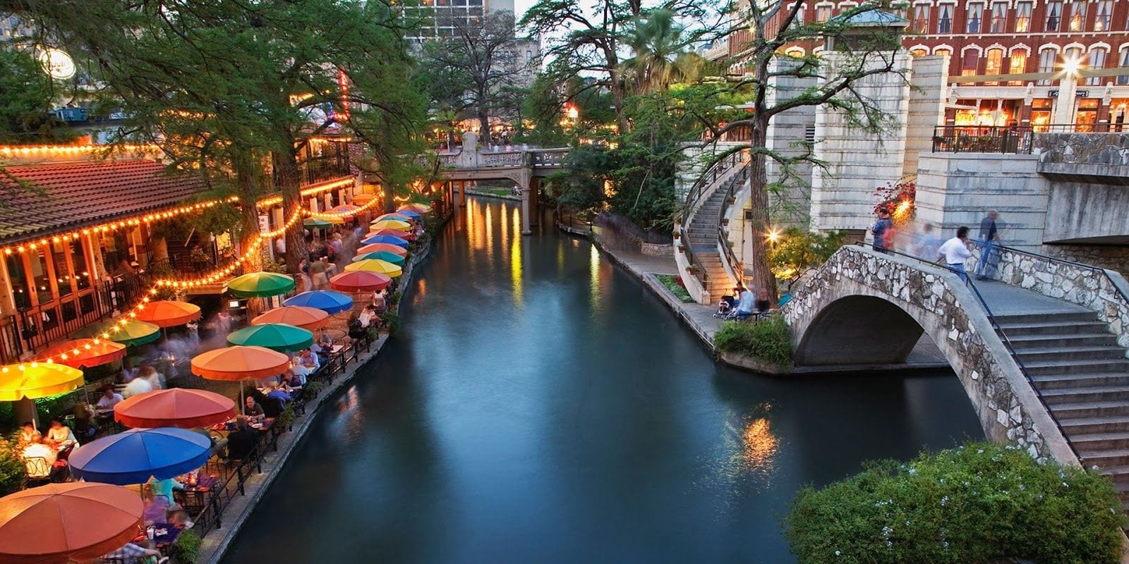 San Antonio River Walk with restaurants and a stone bridge
